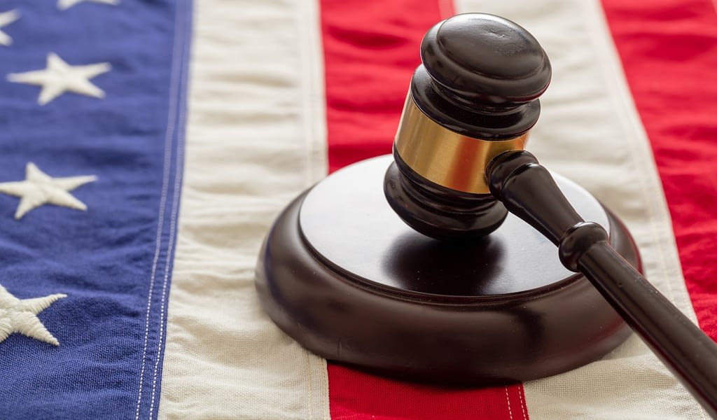 Justice in USA. Law gavel on United States of America flag.